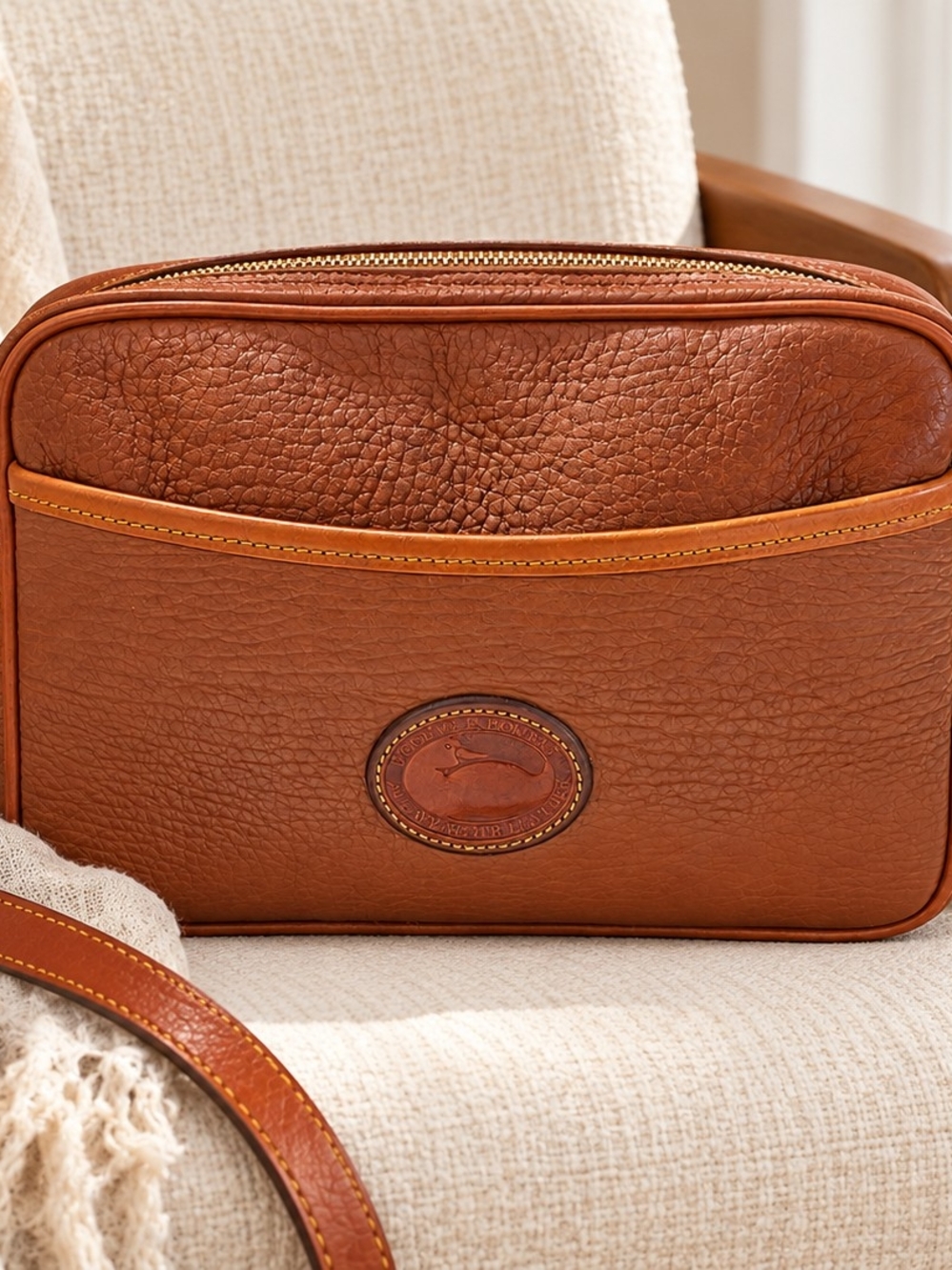 Vintage Dooney & Bourke tan leather crossbody bag with a classic structured came